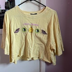 Yellow crop top that says “choose Kindness”